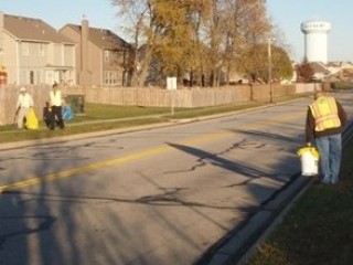 Image of Adopt-A-Street volunteers removing litter from a residential street.