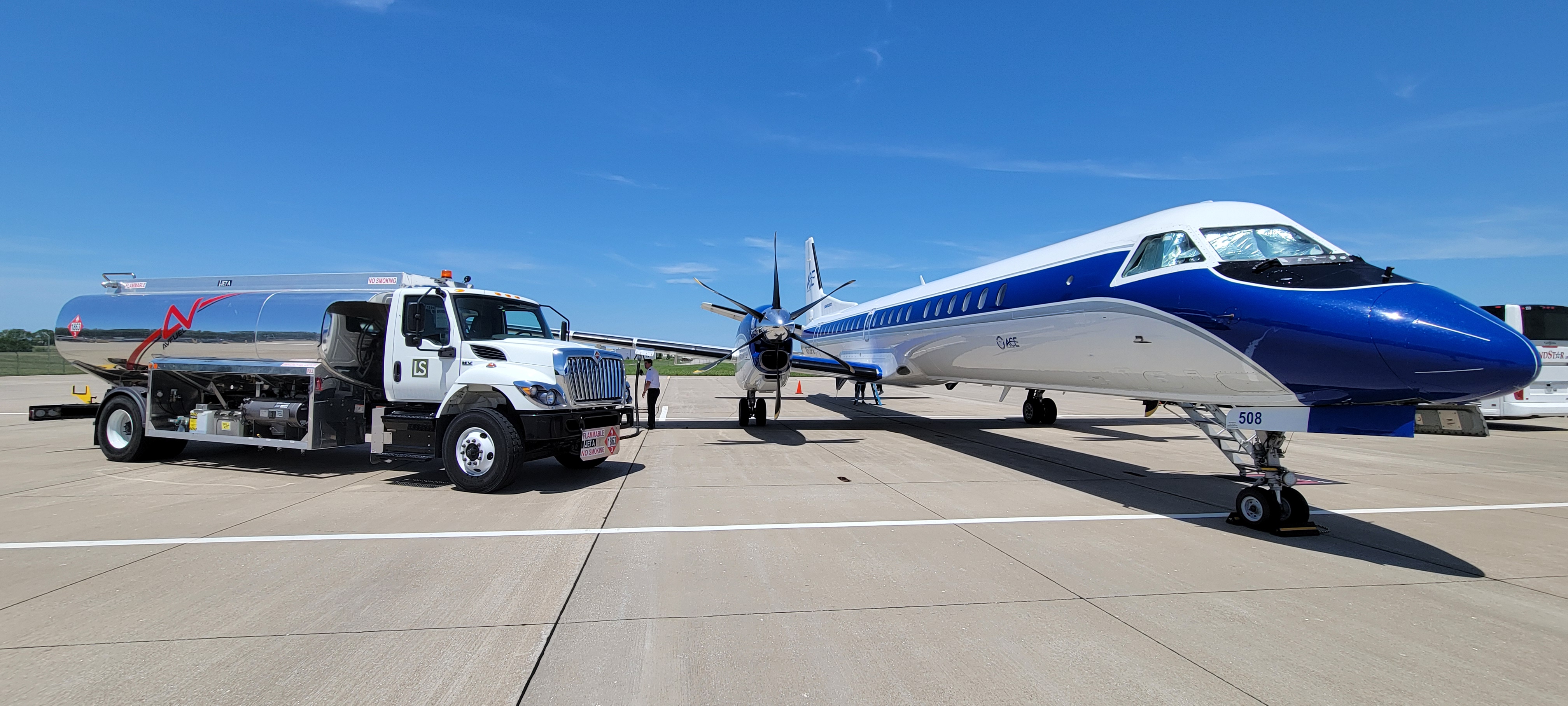 Airplane about to receive fuel on the tarmac. 